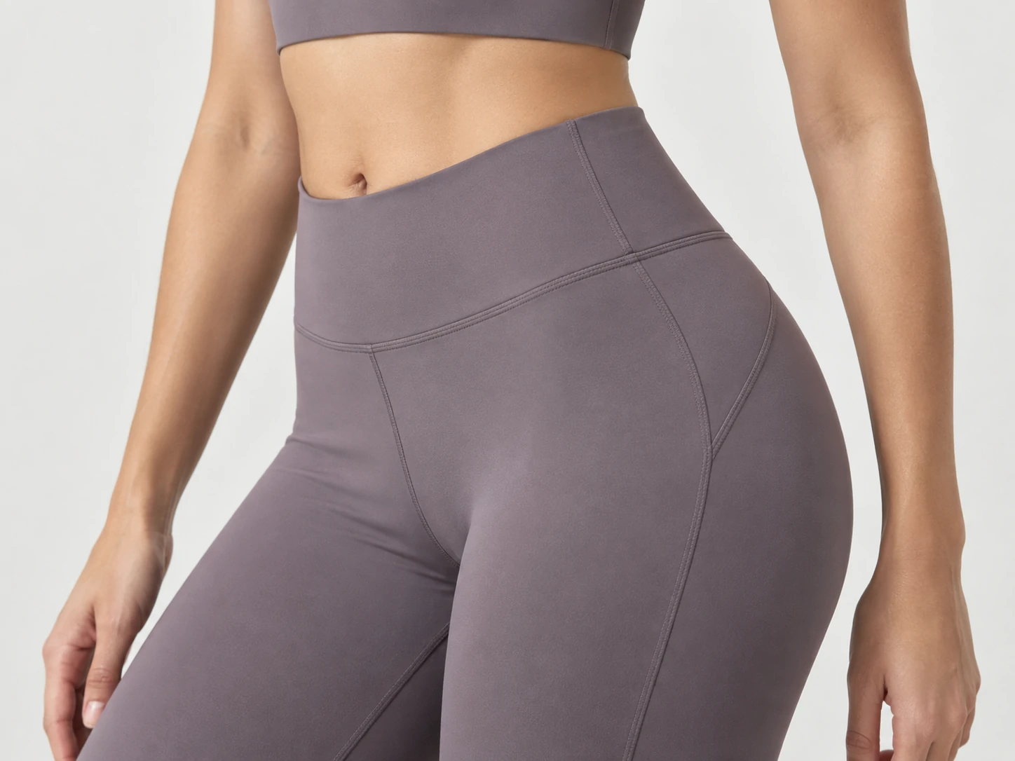 Close-up of women’s high-waisted activewear leggings with contoured waistband and flatlock seams for gym and training wear