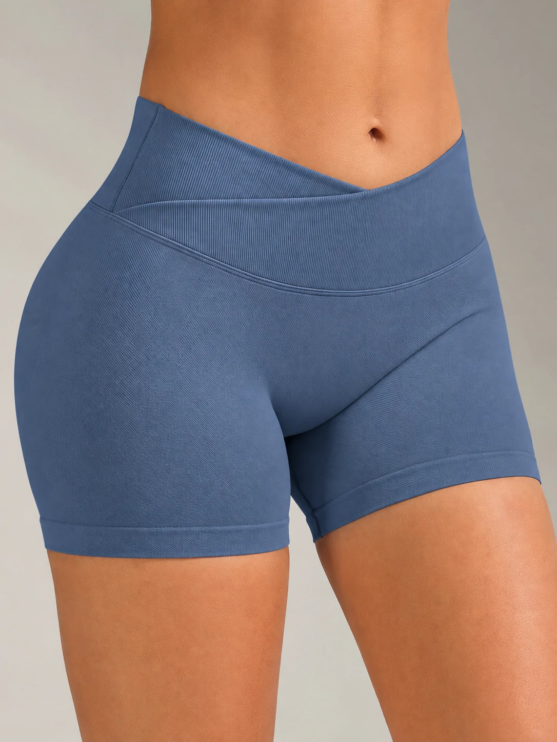 Close-up of blue women’s gym shorts with a crossover high waistband for custom activewear and fitness training