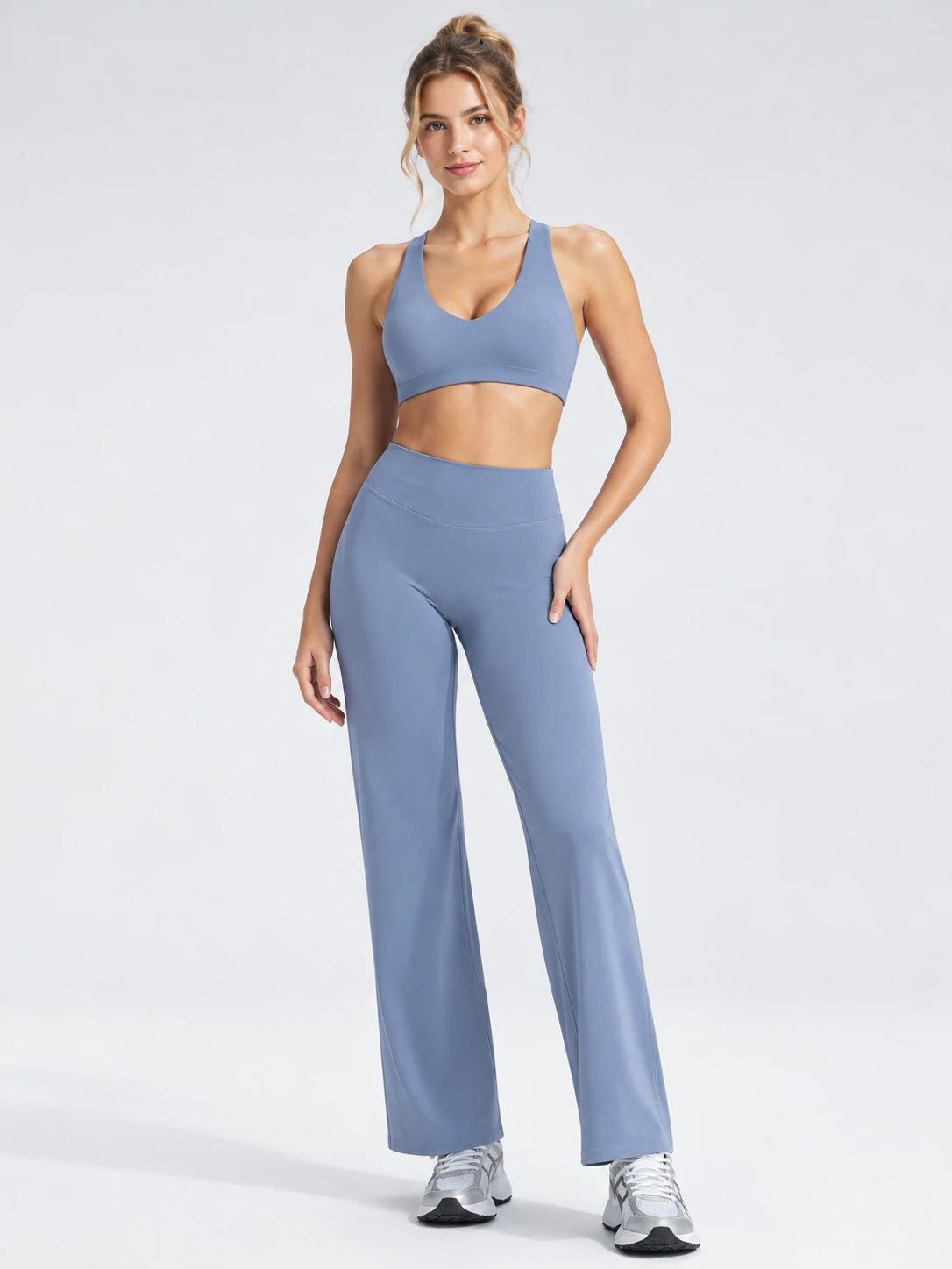 Female model wearing a blue sports bra with matching high-waisted wide-leg activewear pants for women’s custom gymwear