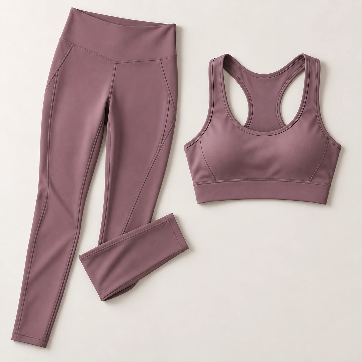 Mauve women’s activewear set with racerback sports bra and high-waisted leggings for custom gymwear production