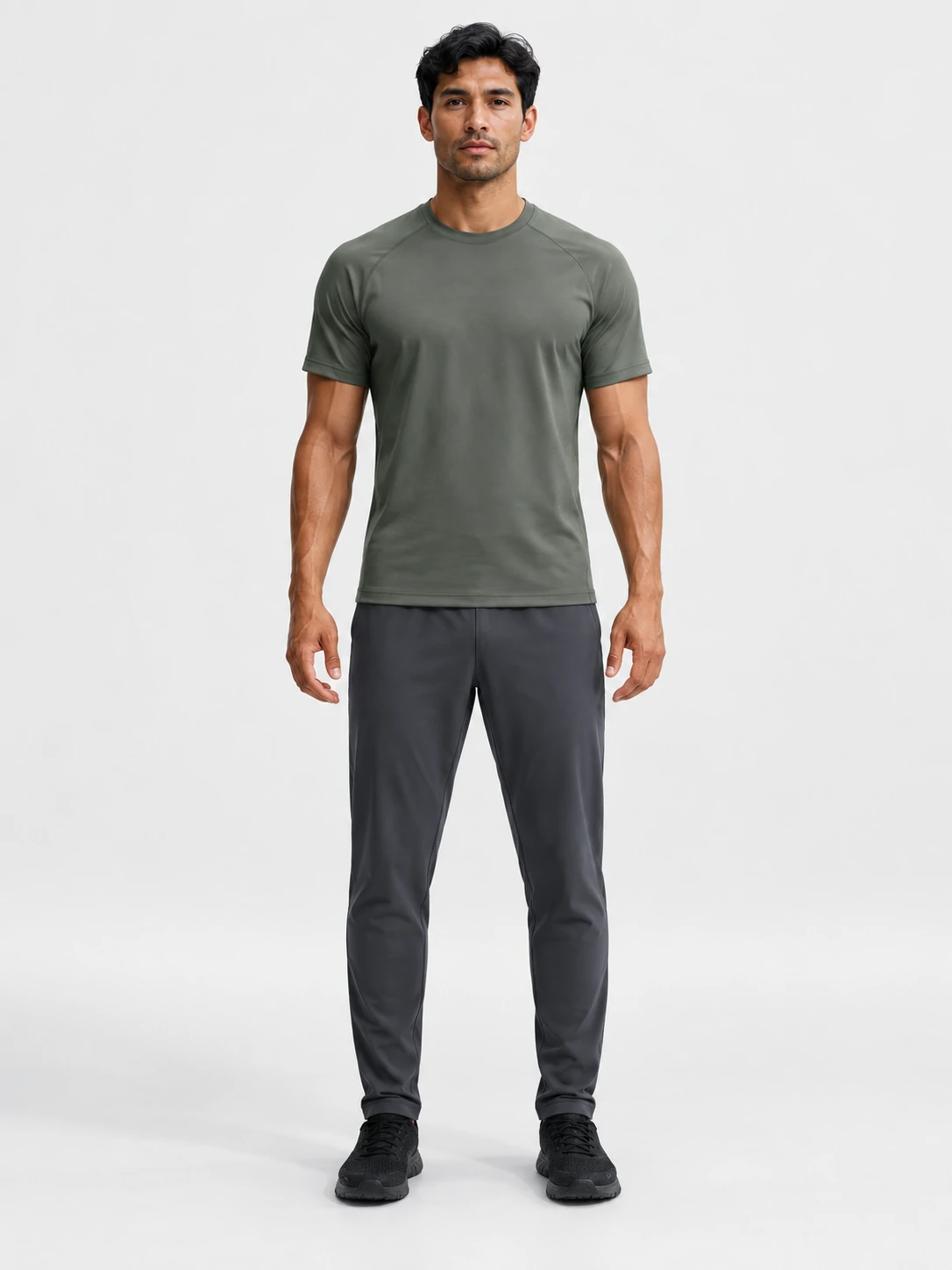 Male fitness model wearing an olive performance T-shirt with dark training pants for men’s custom gymwear and activewear