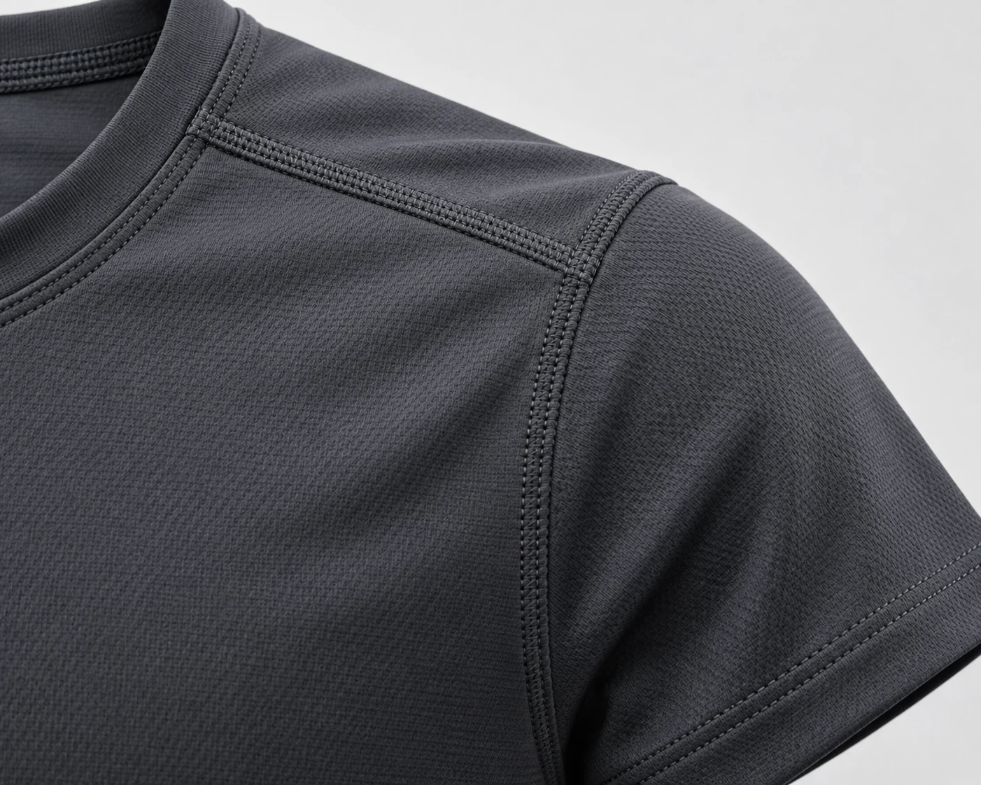 Close-up of a men’s performance gym T-shirt showing reinforced shoulder seams, collar stitching and technical activewear fabric