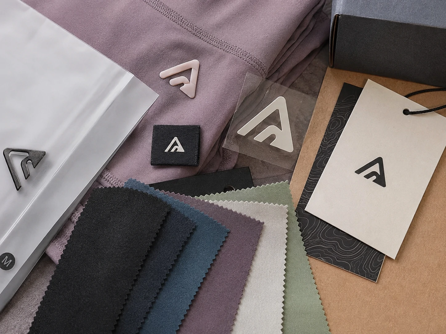 Custom activewear fabric swatches, logo labels, heat transfer branding and hang tags for private label sportswear